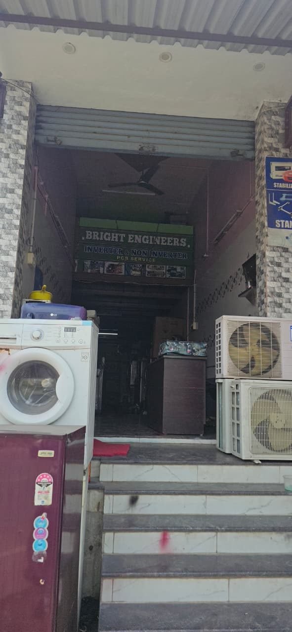 Bright Engineers shop front in Salem with inverter and non-inverter PCB service board, washing machine and AC outdoor units outside